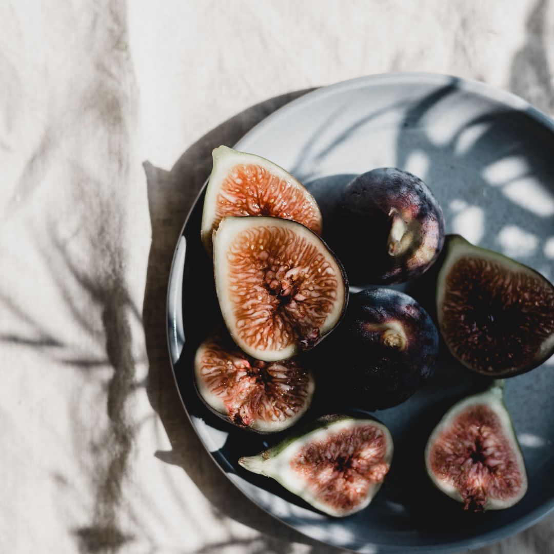 Figs on a plate covered by shadows